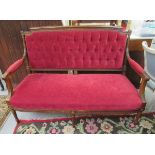 A late Victorian mahogany showwood framed open arm settee,