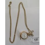 A lady's gold coloured metal cased fob watch with radiating, engine turned ornament,