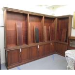 An Edwardian oak L-shaped library bookcase, having a moulded cornice,