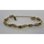 A yellow metal decorative chain link bracelet,