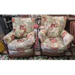 A pair of modern Ercol elm framed easy chairs with cushioned fabric upholstered backs and seats,