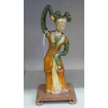 A late 19th/early 20thC Chinese brown and green glazed earthenware figure, a female dancer 12''h,