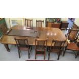 A 1930s oak wind-out dining table, the top with rounded corners, raised on ring turned,