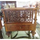 A mid Victorian mahogany and burr walnut finished three division Canterbury with fret carved panels,