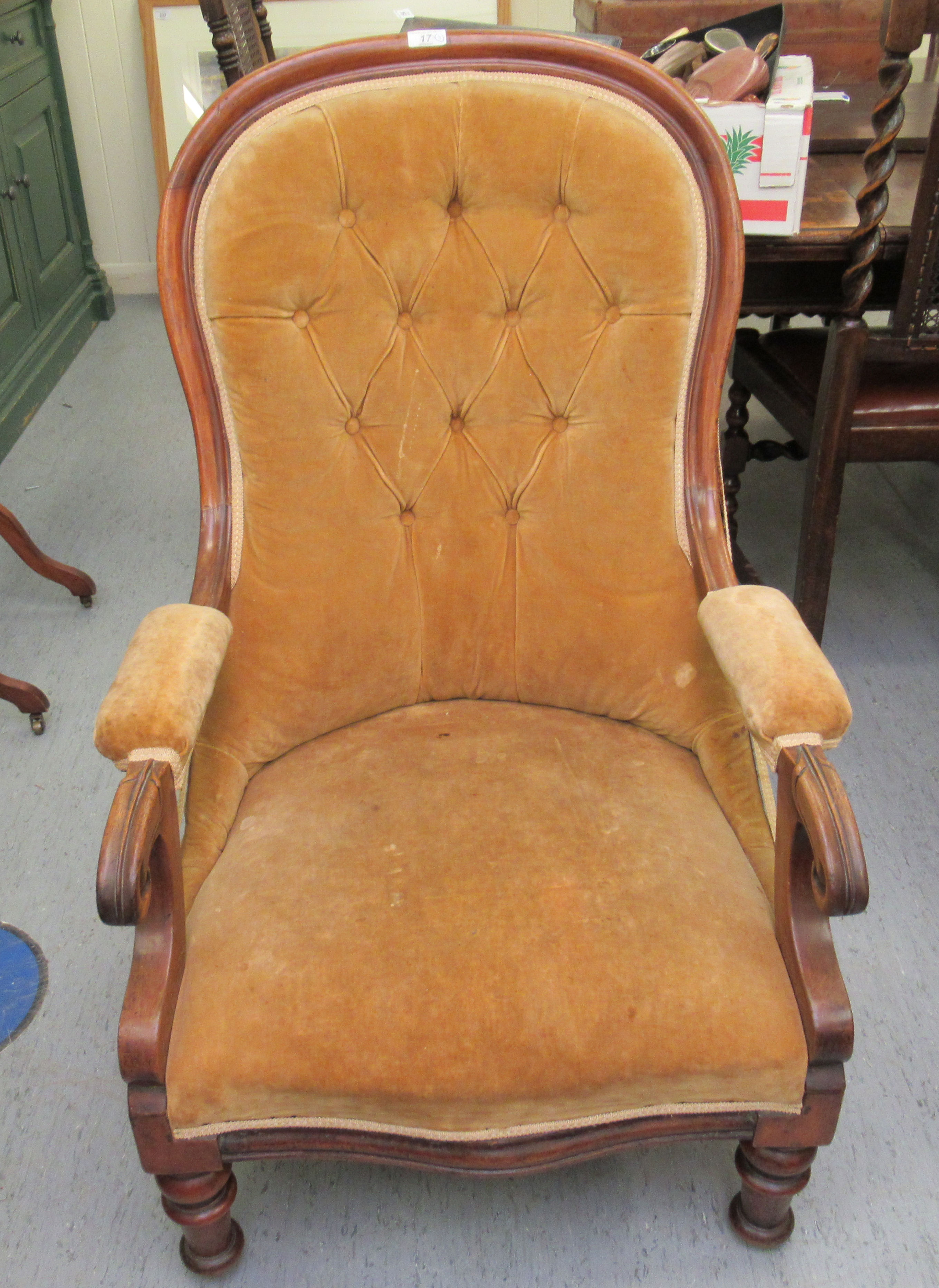 A late Victorian mahogany spoonback nursing chair, button upholstered in gold coloured fabric,