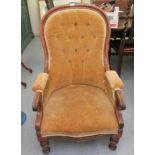 A late Victorian mahogany spoonback nursing chair, button upholstered in gold coloured fabric,