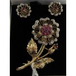 A 9ct gold ruby and diamond set floral brooch;