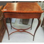 An Edwardian string inlaid and crossbanded mahogany, serpentine outlined table,