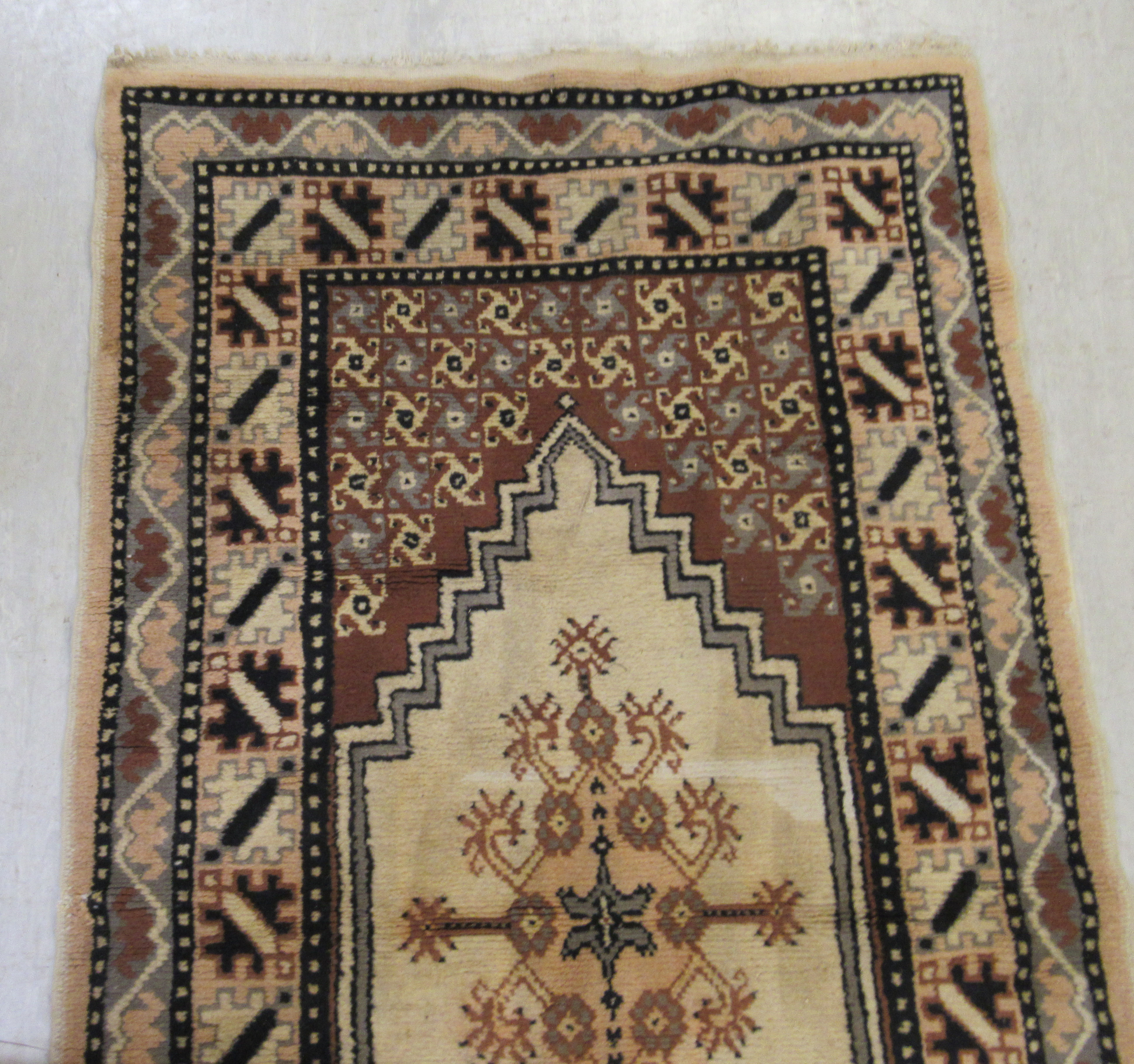 An Indian woollen rug, decorated with stylised designs, - Image 2 of 3