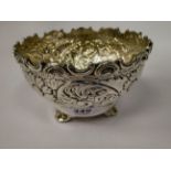 A modern Indian silver coloured metal footed bowl of ogee form,