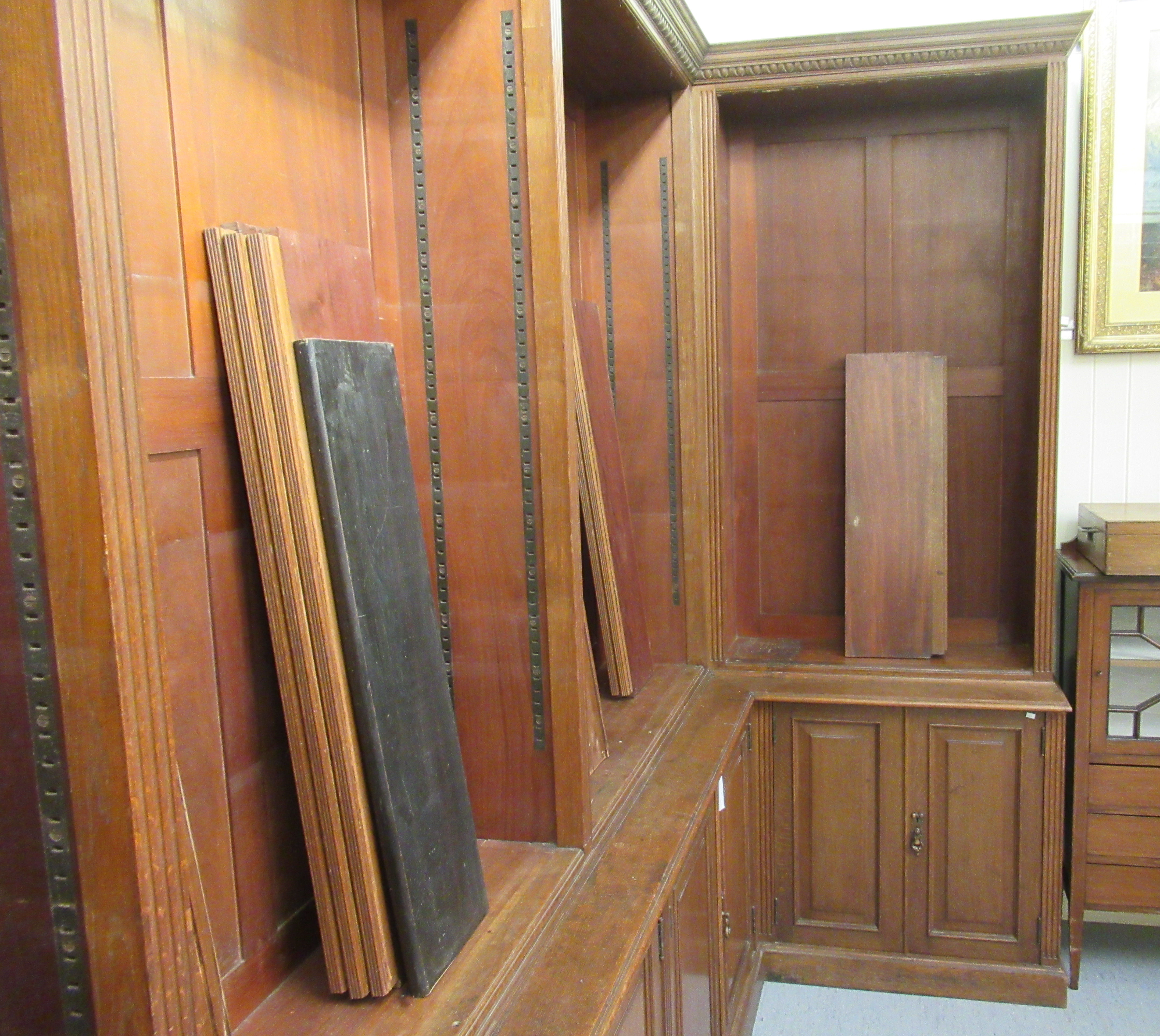 An Edwardian oak L-shaped library bookcase, having a moulded cornice, - Image 4 of 5