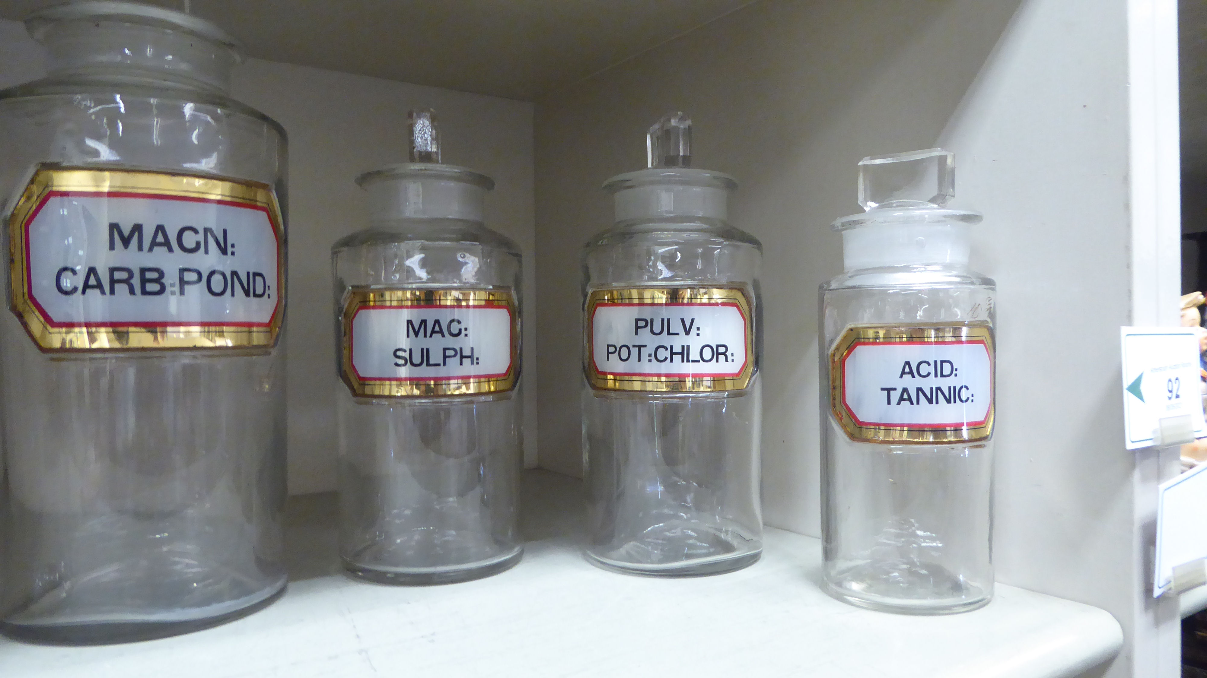 A series of five clear glass chemist's jars of cylindrical form with ground stoppers and labels 6.. - Image 2 of 3