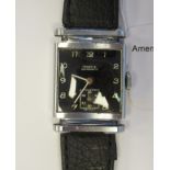 A 1940s Moeris square, stainless steel cased military type wristwatch, faced by a black Arabic dial,