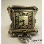 A 1935 traveller's folding, square, engine turned, silver cased watch, faced by an Arabic dial,