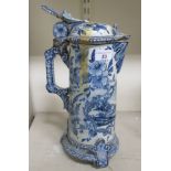 A 19th/20thC Delft tin glazed earthenware jug of tapered, cylindrical form with a loop handle,