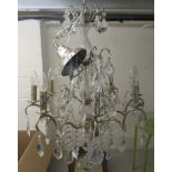 A modern 'antique' inspired shabby chic finished and glass three tier chandelier 27''drop 28''dia