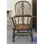 A late 19thC Windsor oak and elm high hoop, spindled and splat back elbow chair,