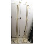 Two modern cream painted cast metal uplighters with frosted glass shades,