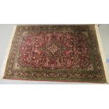 A Kashan part silk/part woollen rug, profusely decorated with flora and foliate designs,