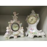 A late 19thC porcelain mantel clock, surmounted by child like figures,
