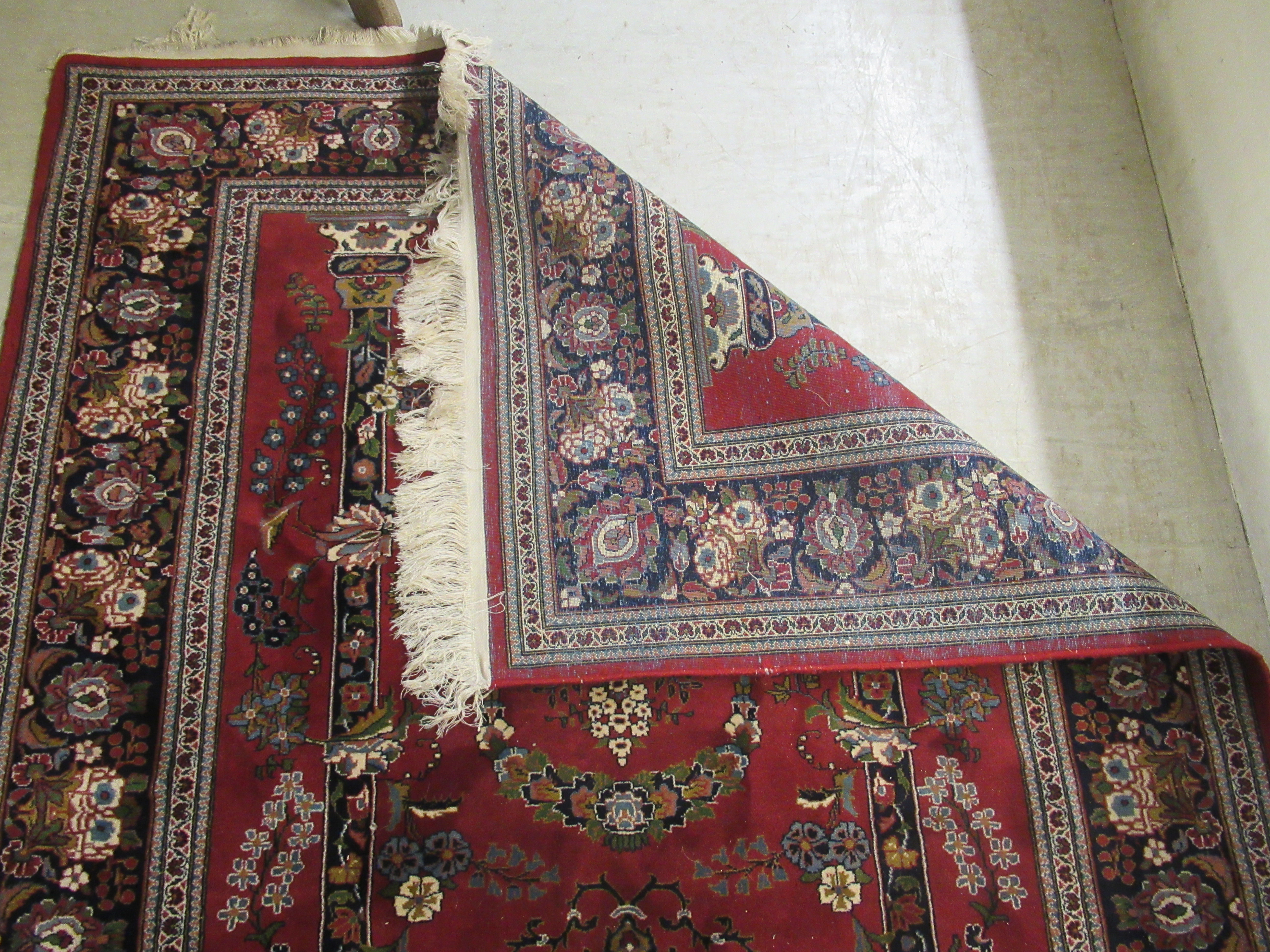 A Persian rug, decorated with pillars, a vase and flora, - Image 3 of 3