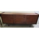 A Younger Ltd teak sideboard with a central bank of four graduated drawers, flanked by two doors,