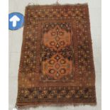 A Persian rug, decorated with block motifs,