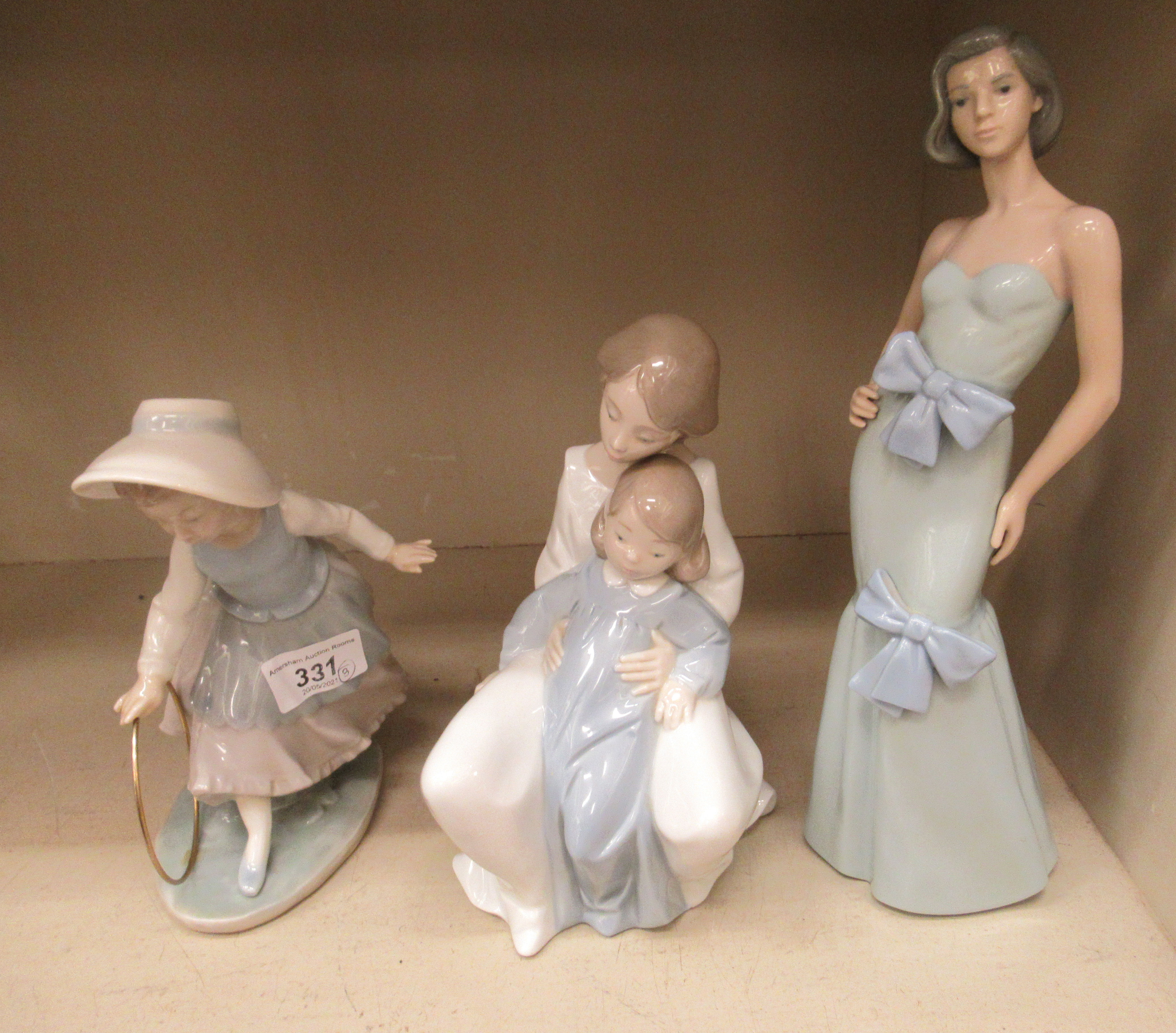 Three Nao porcelain figures: to include a woman wearing an evening dress 12''h OS5