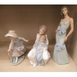 Three Nao porcelain figures: to include a woman wearing an evening dress 12''h OS5