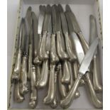 Twelve foreign silver coloured metal pistol grip handled table knives;