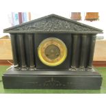 A 1930s black slate cased mantle clock of architectural form, the movement faced by an Arabic dial,