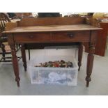 A mid Victorian mahogany washstand with a low gallery, over two in-line drawers,