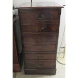 A modern mahogany three drawer filing cabinet, the top with a tooled and gilded green hide scriber,