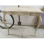 A modern French inspired cream and gilt 'shabby chic' painted serpentine outlined hall table,