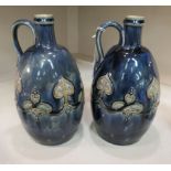 A pair of Art Nouveau Royal Doulton streaky lustre glazed stoneware jugs bears impressed marks