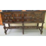 An early 20thC carved oak sideboard with a railed back, over two central,