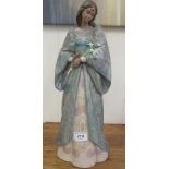 A Lladro porcelain figure 'Privilege' a woman holding a bouquet of flowers 18''h BL