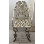 A 20thC white painted cast iron patio chair of ornate scrolled construction BSR