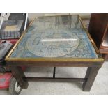 A modern brass bound mahogany coffee table, the top set with a printed world map,