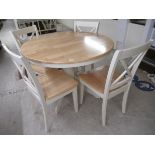 A modern cream painted and beech pedestal breakfast table 30''h 42''dia;
