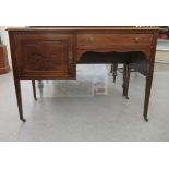 A lady's Edwardian string inlaid mahogany kneehole desk with a tooled green hide scriber,