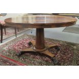 A late Regency rosewood breakfast table, the oval tip-top elevated on a tapered,
