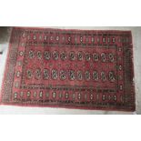 A Turkoman rug, decorated with two columns of two guls,