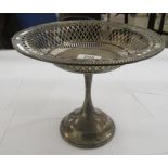 An Edwardian loaded silver pedestal sweet dish with a bead bordered, crossover,
