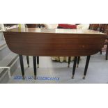 A G-Plan mahogany drop leaf dining table, raised on turned,