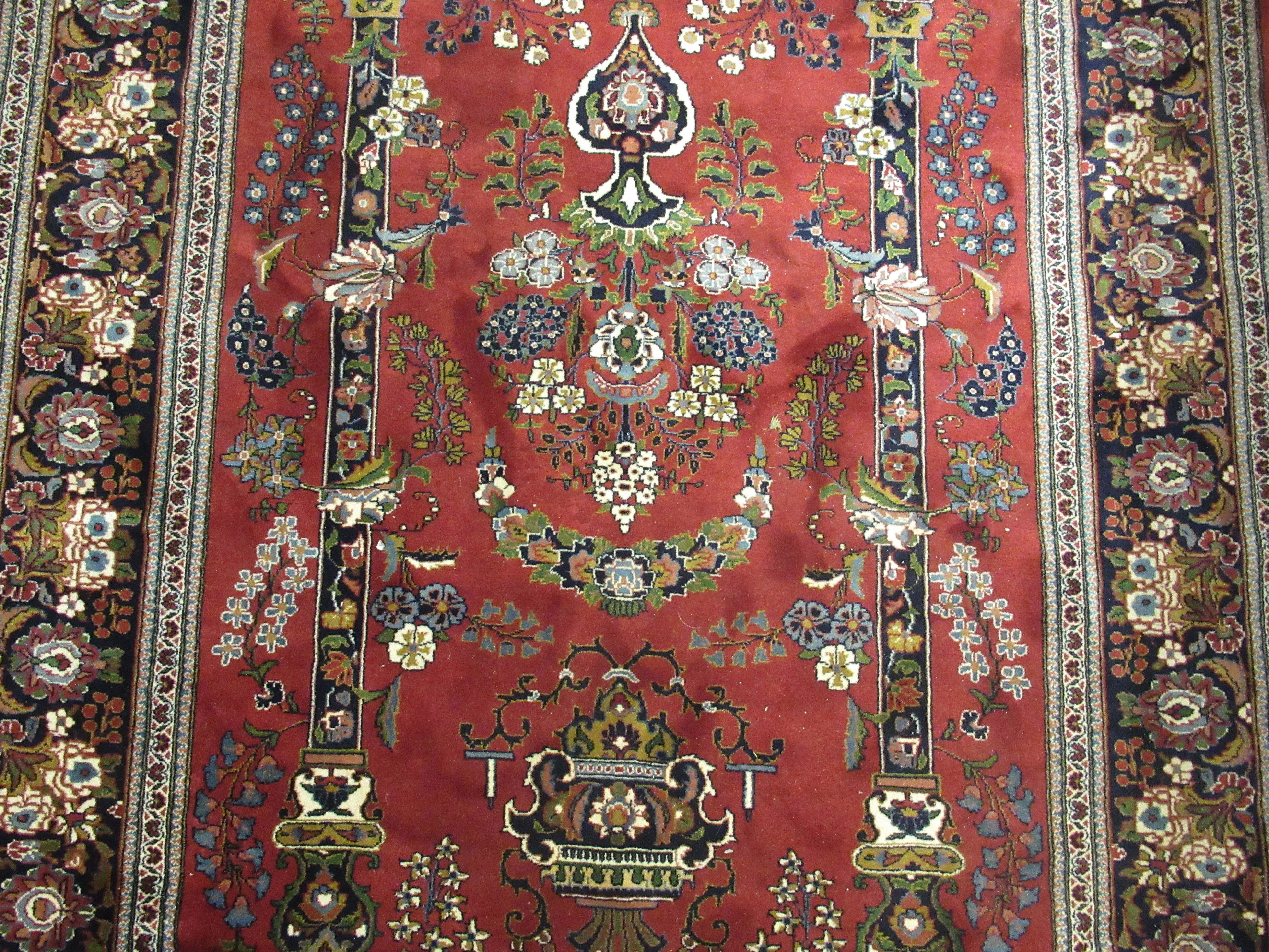 A Persian rug, decorated with pillars, a vase and flora, - Image 2 of 3