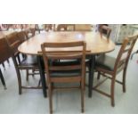 A mid 20thC mahogany dining table, the top with curved edges, raised on ebonised,