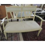 An Edwardian, later cream painted, two person open arm salon settee,