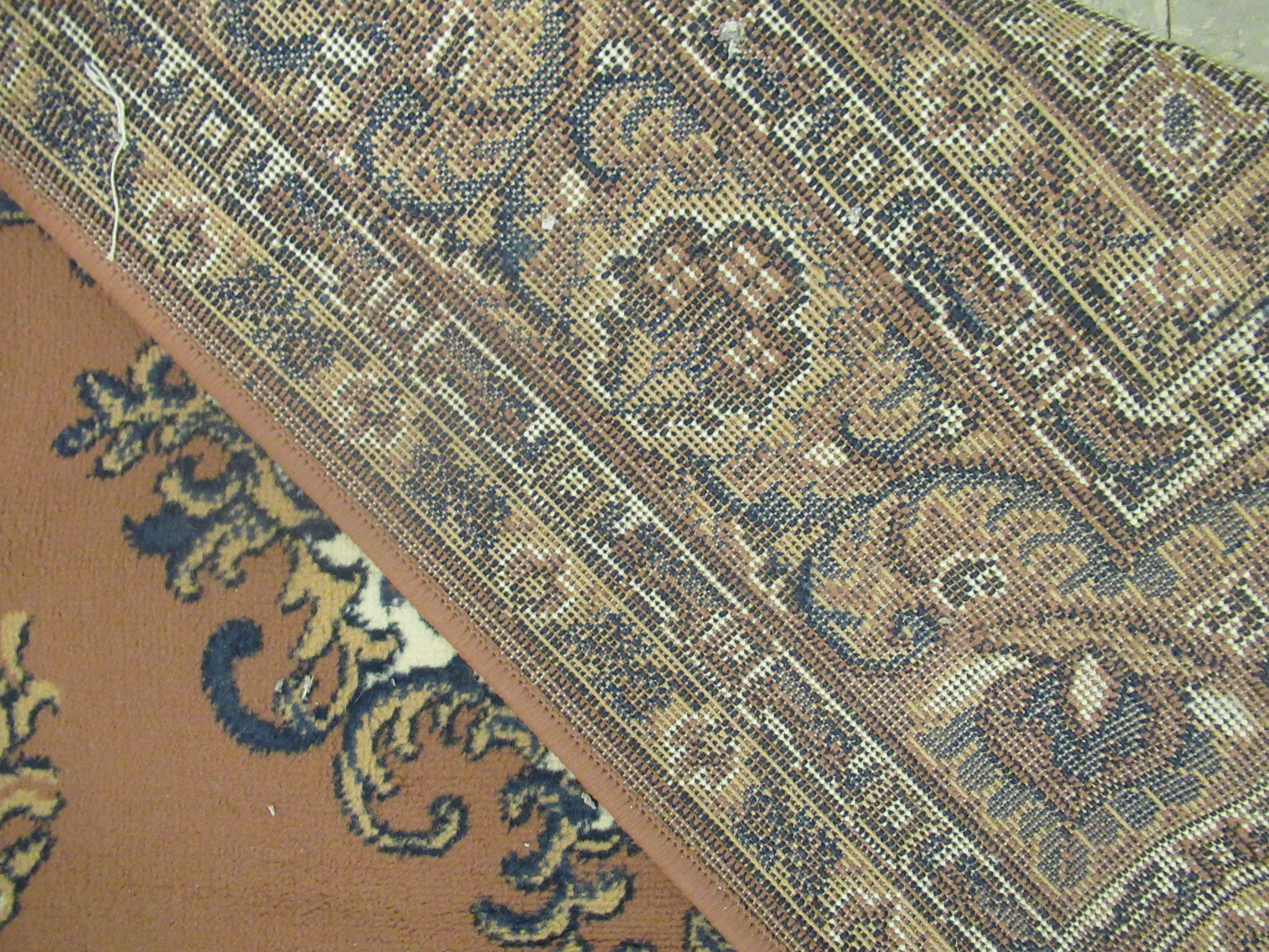 A machine made woollen rug, decorated with repeating squares of floral ornament, - Image 4 of 4