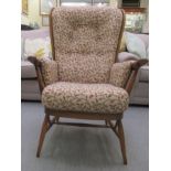 An Ercol Golden Dawn beech and elm framed, high spindled back,